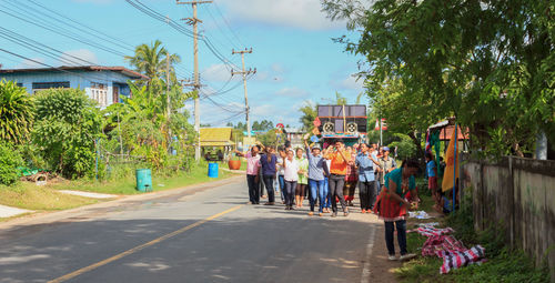 People on street amidst trees