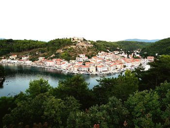 Scenic view of town by buildings against clear sky