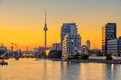 The famous television tower and the spree river in berlin after sunset