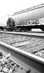 Train by railroad tracks against clear sky