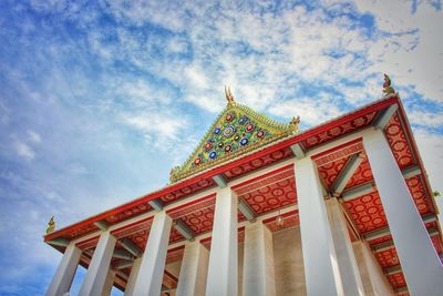 Low angle view of temple building against cloudy sky