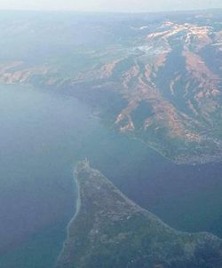 High angle view of land and sea against sky