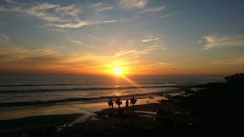 Scenic view of beach against sky during sunset