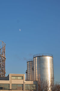 Low angle view of tower against blue sky