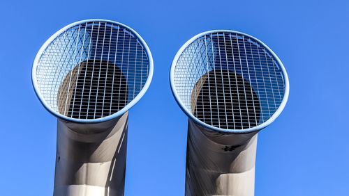 Low angle view of electric lamp against clear blue sky