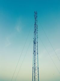 Low angle view of communications tower against blue sky