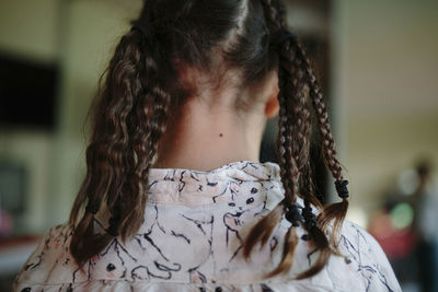 Rear view of girl with braided hair at home