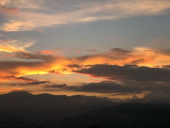 Scenic view of silhouette mountains against sky during sunset