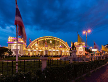 Illuminated buildings against sky at night