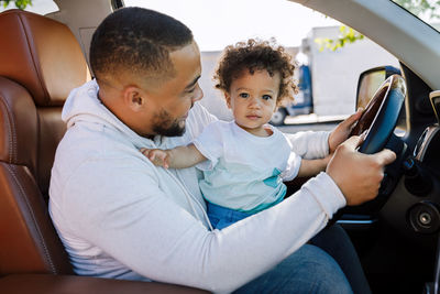 Father with son sitting in car