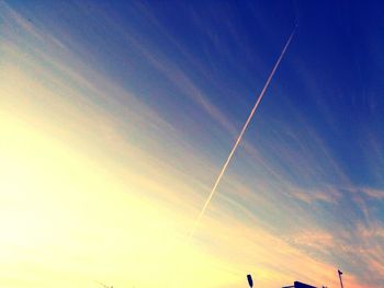 Low angle view of vapor trail in blue sky