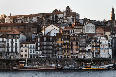 Boats in river against buildings