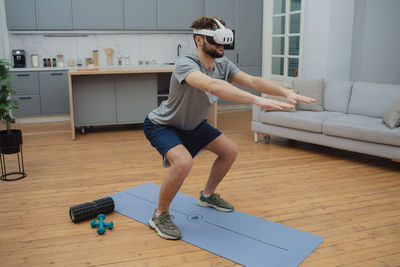 Full length of woman exercising in gym