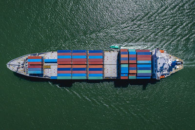 High angle view of containers ship import export international on green sea