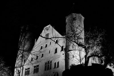 Low angle view of old building against sky at night