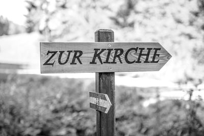 Close-up of road sign against sky