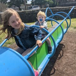 Happy kids on rocket at playground