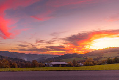 Scenic view of mountains against orange sky