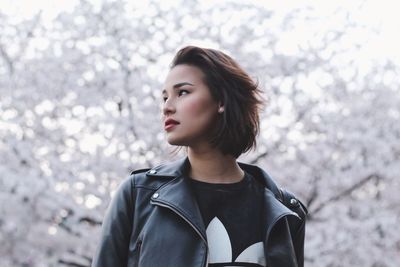 Portrait of beautiful young woman looking away