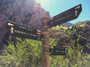 Close-up of signboard against mountains