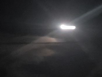 Low angle view of illuminated moon at night