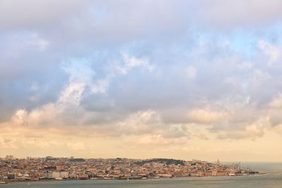 Scenic view of sea by buildings against sky