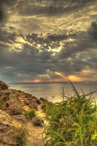 Scenic view of sea against dramatic sky