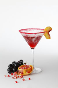 Close-up of fruits in glass against white background