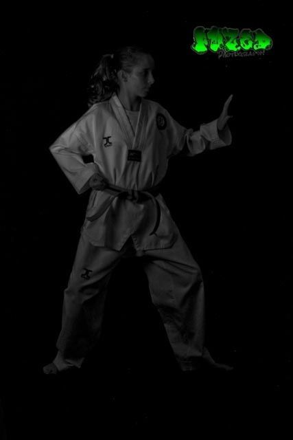 indoors, night, lifestyles, black background, casual clothing, three quarter length, studio shot, leisure activity, dark, full length, person, waist up, front view, childhood, illuminated, standing, copy space, holding