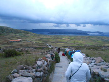 Rear view of man against sky