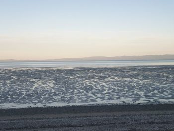 Scenic view of sea against clear sky during sunset