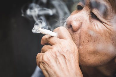 Close-up of man smoking cigarette