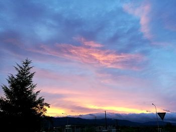 Silhouette of mountain against cloudy sky