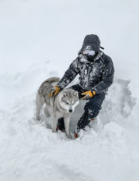 View of a dog on snow covered field