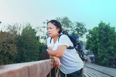 Woman looking away on footbridge