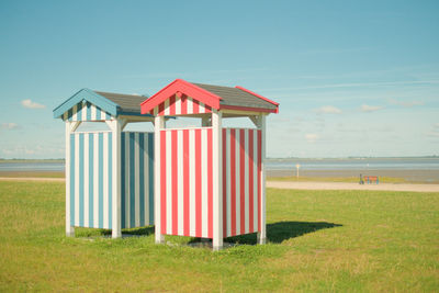 Built structure on field against clear blue sky