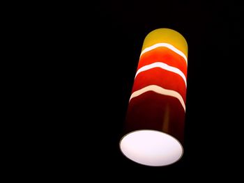 Low angle view of light bulb against black background