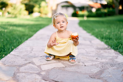 Cute boy on footpath