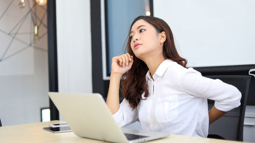 Young woman using laptop at home