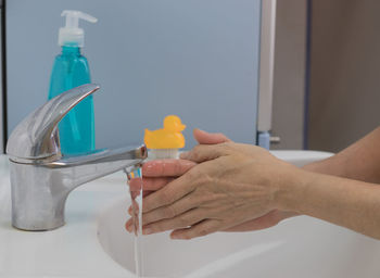 Close-up of hand holding bottle