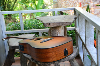 Close-up of wooden table by plants in yard