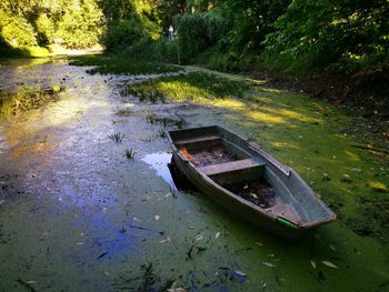 Abandoned boat moored on shore