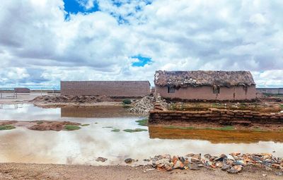 View of birds by building against sky