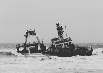 Ship in sea against clear sky