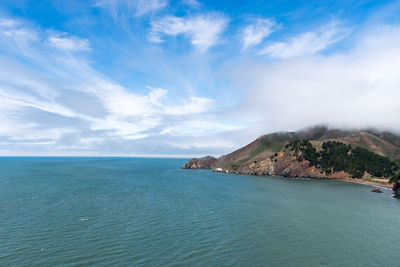 Scenic view of sea against cloudy sky