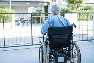 Asian senior or elderly old lady woman patient on electric wheelchair with remote control  