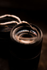 Close-up of camera on table against black background