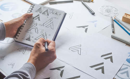 High angle view of drawing on paper at table