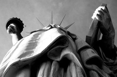 Low angle view of statue of liberty against sky