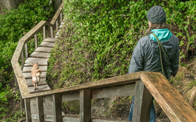 Woman and dog walking down steps